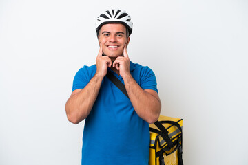 Young caucasian man with thermal backpack isolated on white background smiling with a happy and pleasant expression