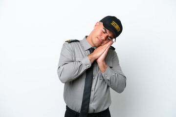 Young caucasian security man isolated on white background making sleep gesture in dorable expression