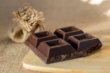 Chocolate on wooden, burlap bag in background