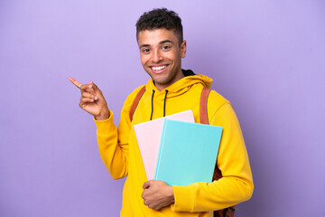 Young student Brazilian man isolated on purple background pointing finger to the side