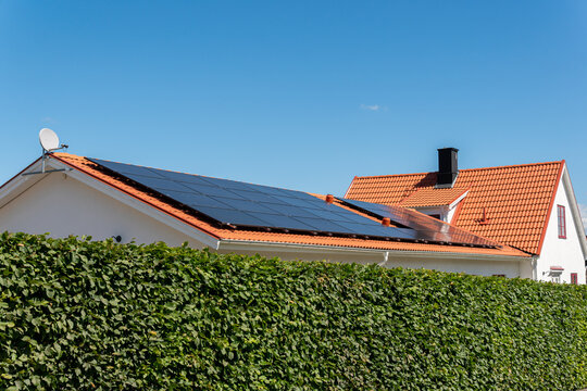 Solar battery panel on a roof of a private house in Europe. Energy-saving technology. Sunny summer day.