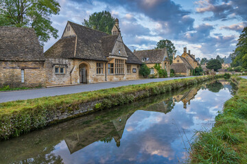 Fototapeta na wymiar A colourful sky above the village of Lower Slaughter in the Cotswolds, Gloucestershire., England.