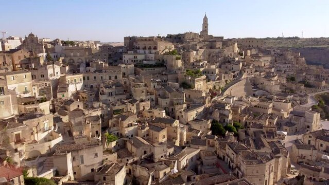 Aerial footage of Sassi di Matera, Basilicata, South Italy.Drone view of Sasso Caveoso and Civita districts, old city houses carved in rock caves, bell tower of Cathedral, Unesco heritage from above