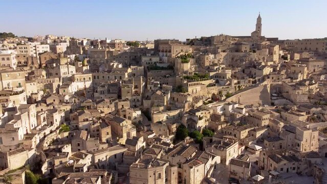 Aerial footage of Sassi di Matera, Basilicata, South Italy. Drone view of Sasso Caveoso and Civita districts, old city houses carved in rock caves, bell tower of Cathedral, Unesco heritage from above