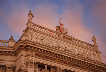 Obraz premium The Burgtheater is court theater in Vienna Hofburg. one of oldest theaters not only in Austria, but throughout Europe. over sunset sky