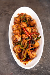 fried dumplings with spices on a white plate top view