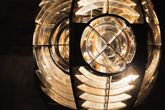 Close up photo.of a ;ighthouse lamp with a Fresnel lens