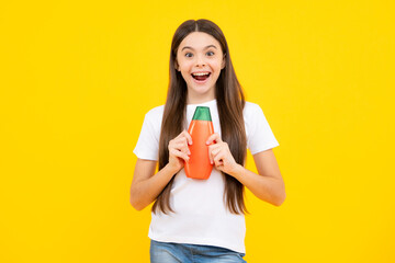 Child teen girl with shampoos conditioners and shower gel. Long hair care of teenager. Presenting cosmetic product, shampoo bottle. Excited teenager, glad amazed and overjoyed emotions.