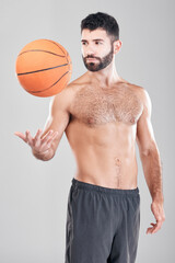 Fitness, sport and man throwing basketball in air, topless sports player isolated on grey background. Exercise, motivation and training, male model with workout mindset and strong muscle in studio.