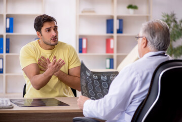 Young male patient visiting old male doctor