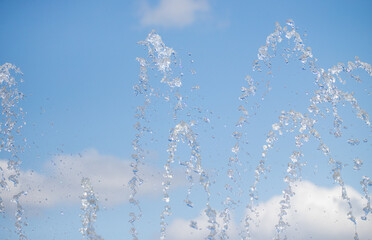 Obraz na płótnie Canvas splashing water from a fountain against the blue sky