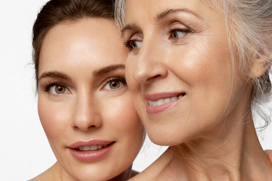 Beauty portrait of beautiful women of two generations on white background.
