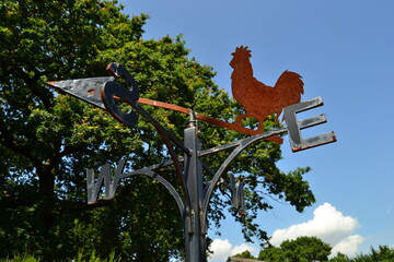 metal weather cock West and East