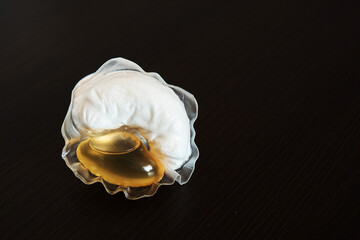 Capsule for washing in a washing machine on a dark background. Close-up.