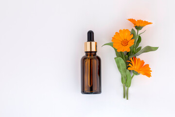 Mockup cosmetic face serum brown glass bottle with a pipette on a white background and...