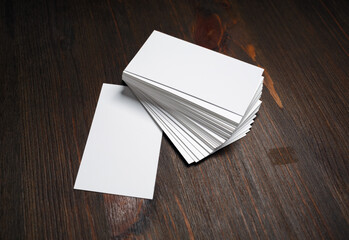 Blank white business cards on wooden background. Mockup for ID. Template for graphic designers portfolios.