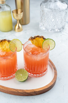 Jungle Bird cocktail in rocks glass garnished with lime and pineapple