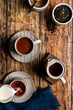 Breakfast black tea with cream on wood surface