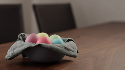 easter eggs in a bowl on walnut table
