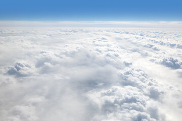 Clouds outside the window in an airplane in flight