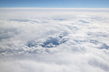 Clouds outside the window in an airplane in flight