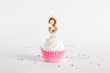 Birthday cupcake with number four candle on white background