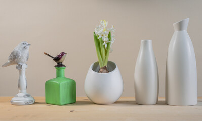 Spring Scandinavian cozy home decor: white vases, white hyacinth and bird figurines