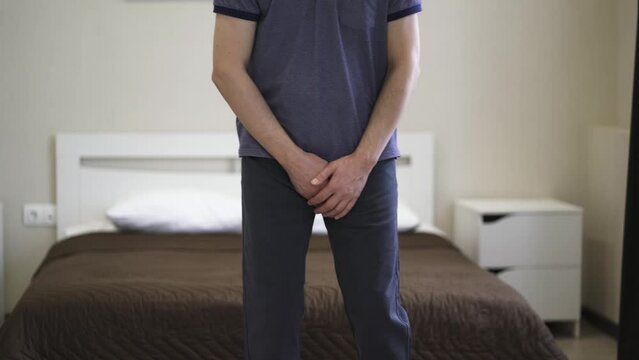 Male fertility concept, pain in prostate, man suffering from prostatitis or from a venereal disease at home, urological genital infections