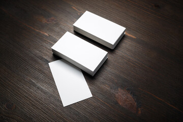 Blank business cards on wood table background. Mockup for ID.