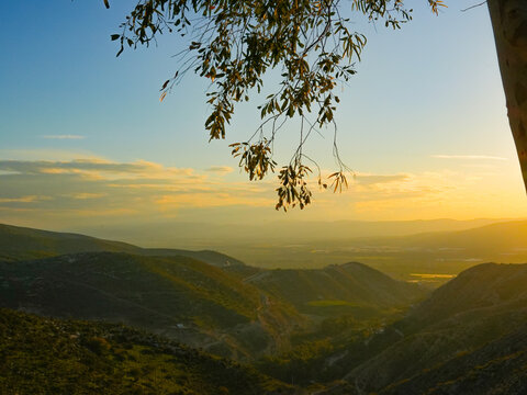 umm qais - irbid, jordan 06- Feb- 2023 - buetiful sunset at  jadara, irbid- jordan and slightly cloudy sky with yellow and blue scene