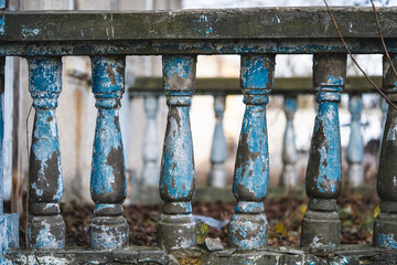 a balustrade on the railing of an old cracked staircase