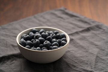 Fototapeta na wymiar Fresh organic blueberries in a white bowl closeup