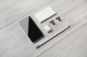 Blank branding stationery and smartphone on wooden background. For design presentations and portfolios.