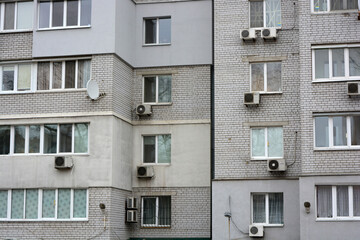 Multi-storey houses made of white, red bricks, a lot of closed balconies and white windows. The house stands in the city of Dnipro, ukraine.