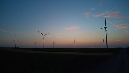 Windmill farm park and turbines for producing green electricity.