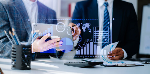 Team colleagues wear formal attire to work together to optimize business processes by using new technologies. high tech hologram in office background.