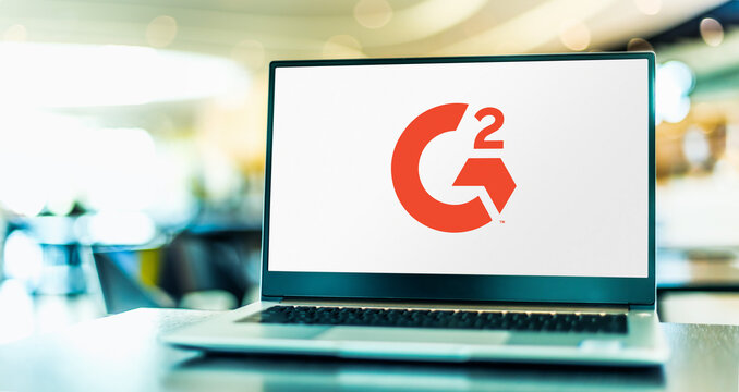 Laptop computer displaying logo of G2.com