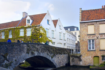 Fototapeta na wymiar Water canal and stone old bridge in Brugge, Belgium
