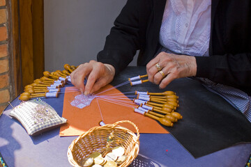 Hands of an elderly lady weaving lace in Bruges