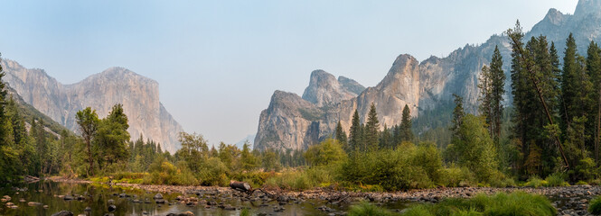 Typical postcard of El Capitan and nearby mountains with the Merced River in the foreground, Yosemite NP - obrazy, fototapety, plakaty