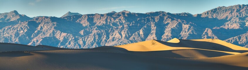 Panoramic view of mountains and dunes at golden hour at Mesquite Flat Sand Dunes within Death Valley
