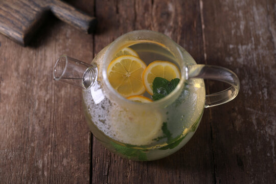 Sbiten, a drink with lemon, mint and honey in a glass teapot