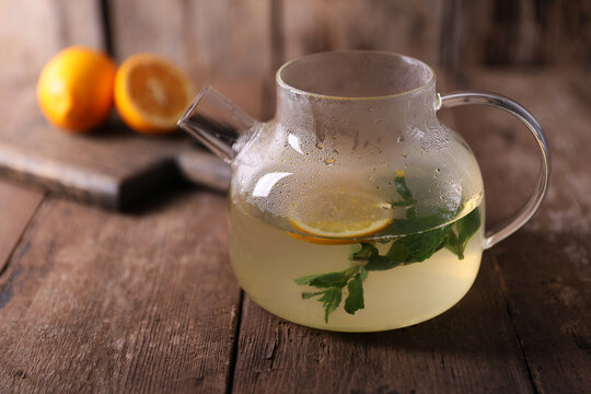 Sbiten, a drink with lemon, mint and honey in a glass teapot