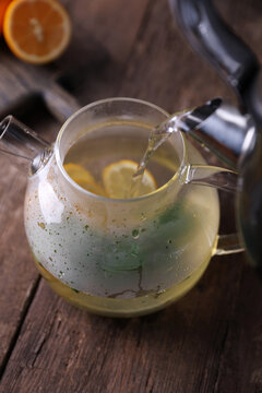 Sbiten, a drink with lemon, mint and honey in a glass teapot