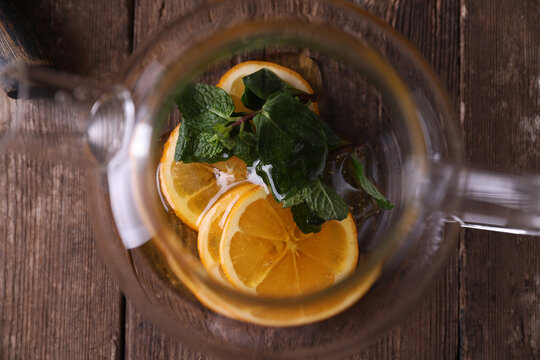 Sbiten, a drink with lemon, mint and honey in a glass teapot