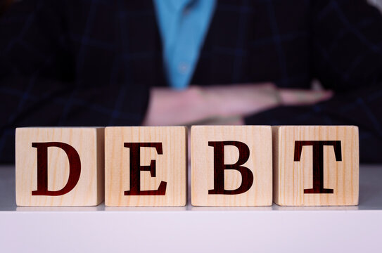 The word "Debt" written on wood cube. Business concept