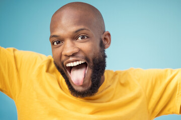 Black man, portrait or tongue on blue background, isolated mockup or wall backdrop mock up for comic, silly or emoji expression. Happy, funny face or goofy student with fashion, trend or cool clothes - obrazy, fototapety, plakaty