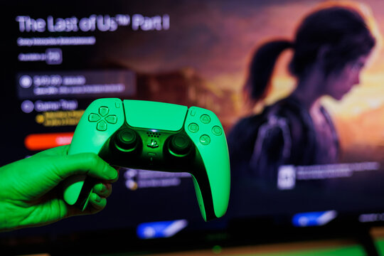 PlayStation 5 Sony reveals PS5 console and games. Dualsense controller. The Last of Us Remastered is PS5's biggest launch game. Man holding joystick