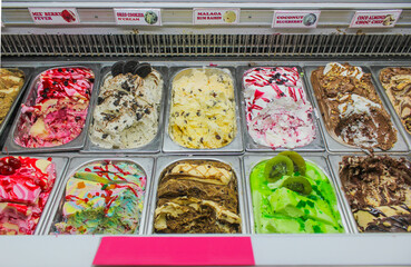 A variety of flavors of ice cream fridge.
