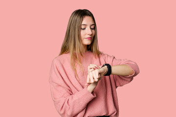 A young woman admiring her sleek and modern smartwatch for convenient timekeeping.